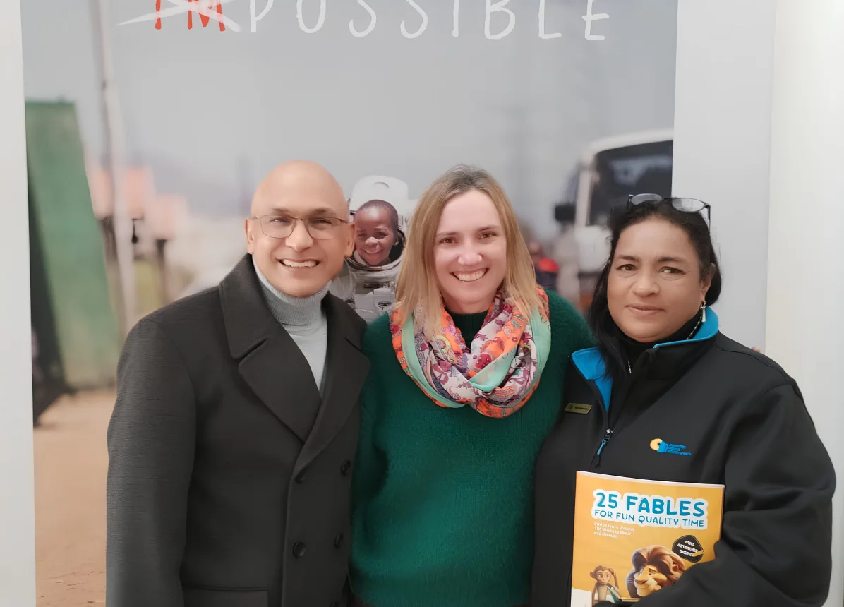 Christel House South Africa representatives with a FableReads book.